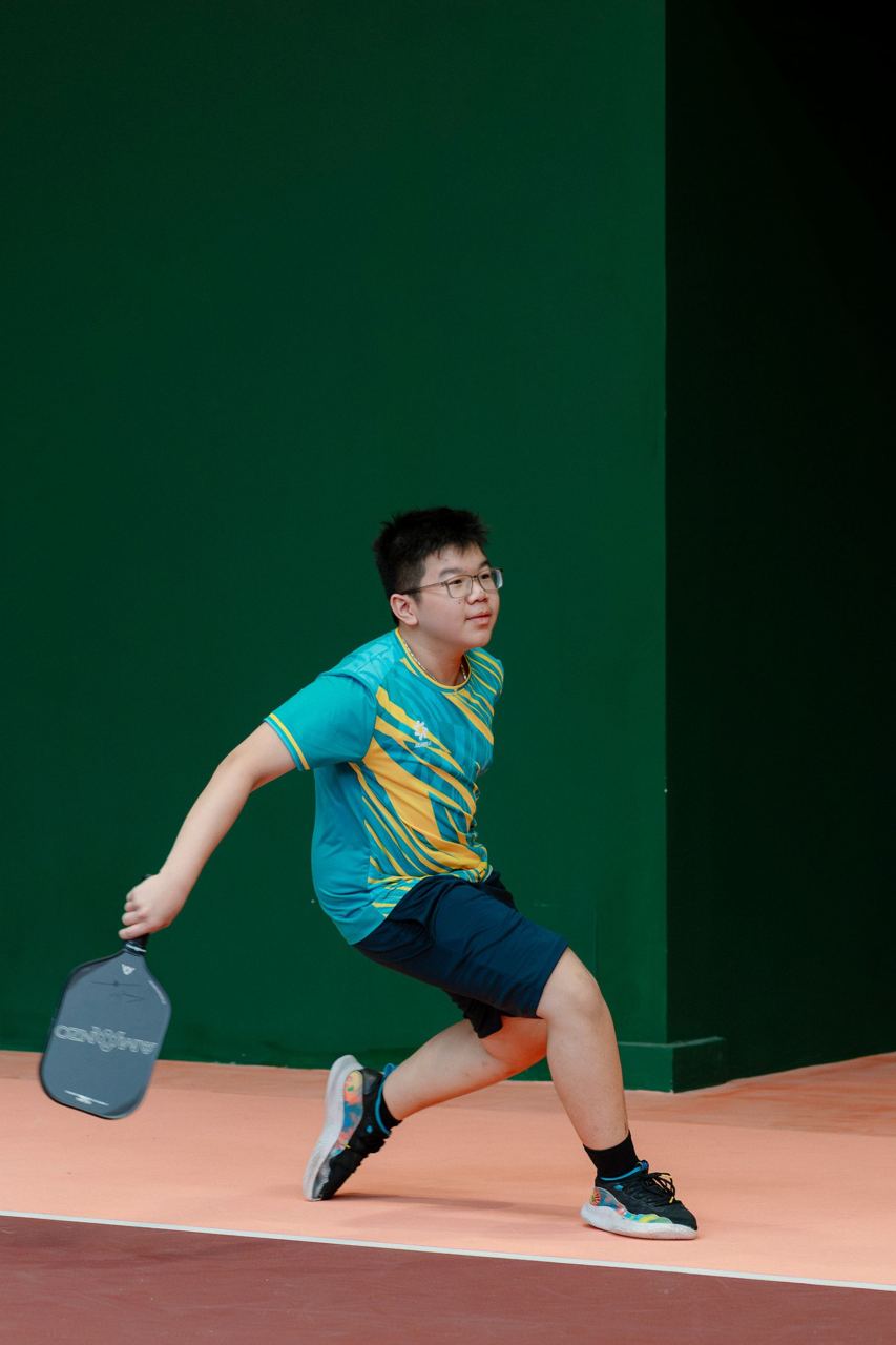 Recreational player preparing a pickleball shot indoors, illustrative photograph