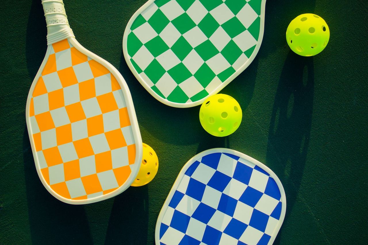 Colorful paddles and perforated balls, illustrative equipment photograph