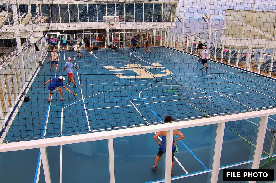 Two pickleball players facing off on an outdoor court