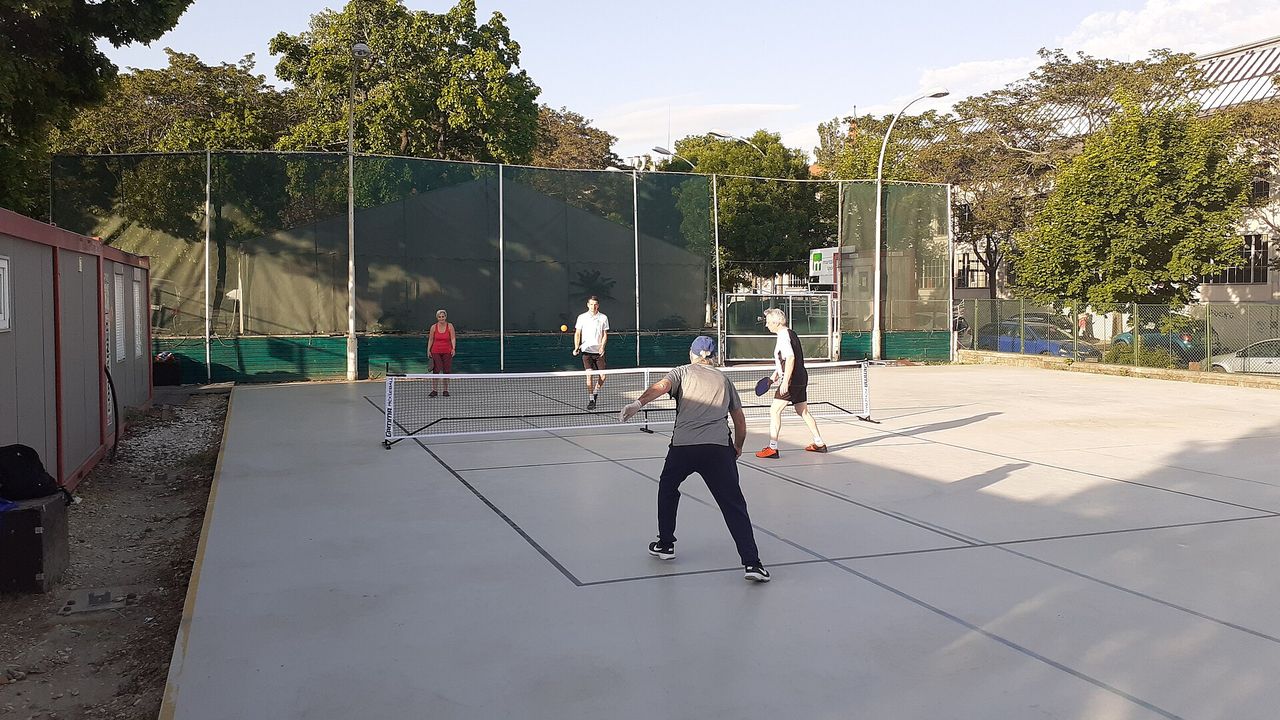 Players at a pickleball training session in a hall in Hungary