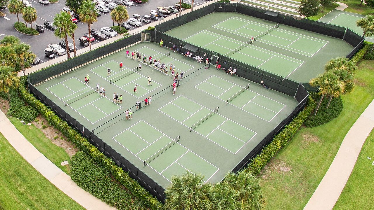 Aerial view of a large pickleball court complex with several courts in use