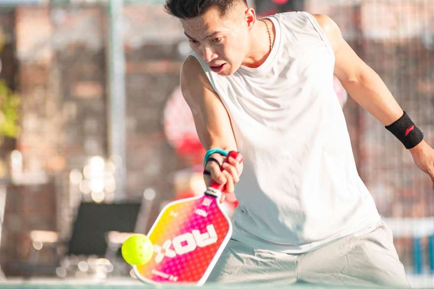 A pickleball player on an indoor court