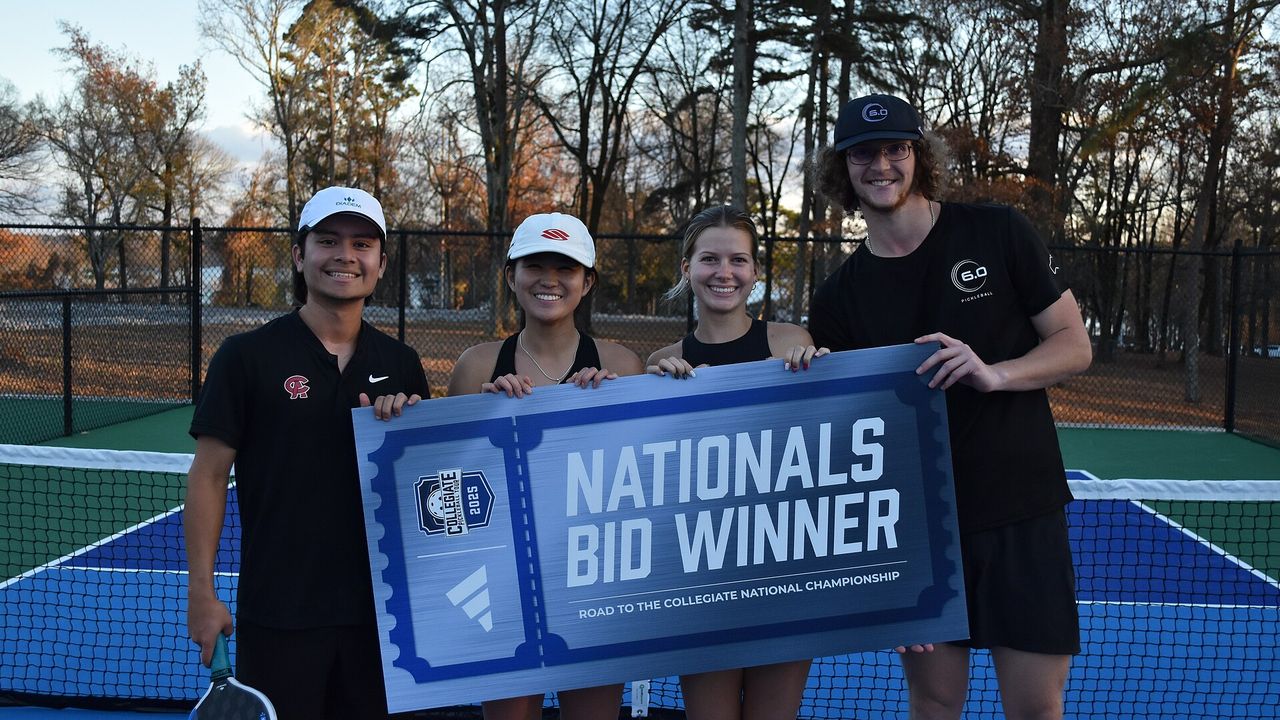 A university pickleball club team holding a "Nationals Bid Winner" banner