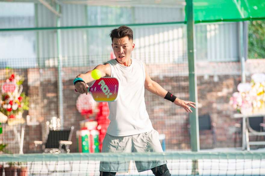 A pickleball player on an indoor court