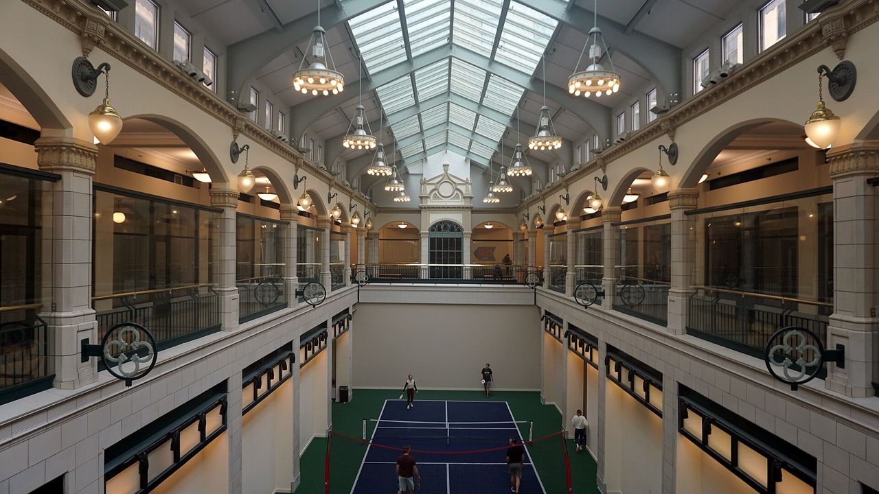 A pickleball court inside a historic glass-roofed arcade in Milwaukee