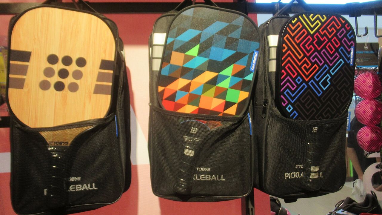 Three decorated pickleball paddles side by side