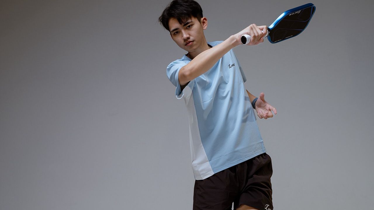 A player in a pickleball match, shown mid-stroke
