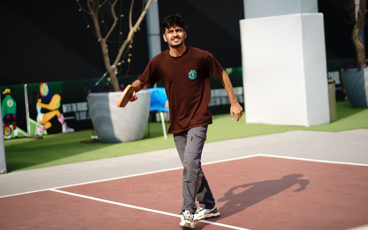 Recreational pickleball player on an outdoor court, illustrative stock photograph